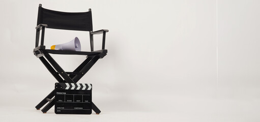 Black director chair and Clapper board with yellow megaphone on white background