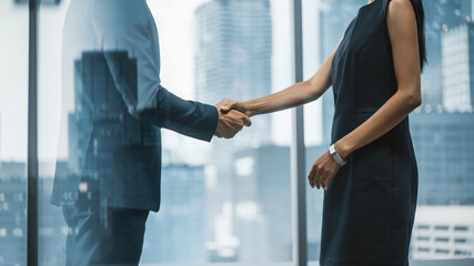 Female and Male Business Partners Meet in Office, Shake Hands. Corporate CEO and Finance Manager...
