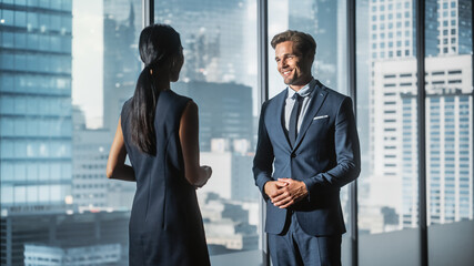 Female and Male Business Partners Meet in Office, Talking. Corporate CEO and Finance Manager Have Meeting in City Office. Businesspeople Came to Discuss Real Estate Purchase and Marketing Project.