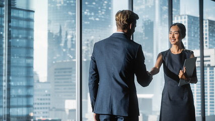 Female and Male Business Partners Meet in Office, Shake Hands. Corporate CEO and Finance Manager...