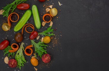  Fresh vegetables on black background. Top view.