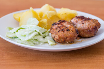 Ground cutlets (kotlety mielone) with mizeria and potatoes. - obrazy, fototapety, plakaty