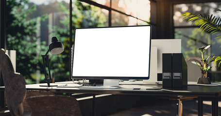 Computer all-in-one with a blank screen front in industrial loft green ecological office interior