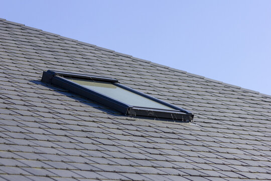 Closeup shot of a skylight or Velux window on a slate roof