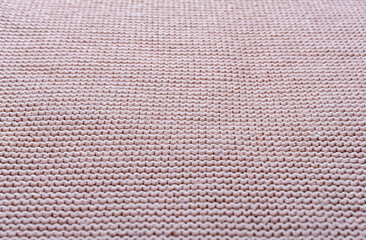 The texture of a beautiful knitted fabric. The pattern is clearly visible.