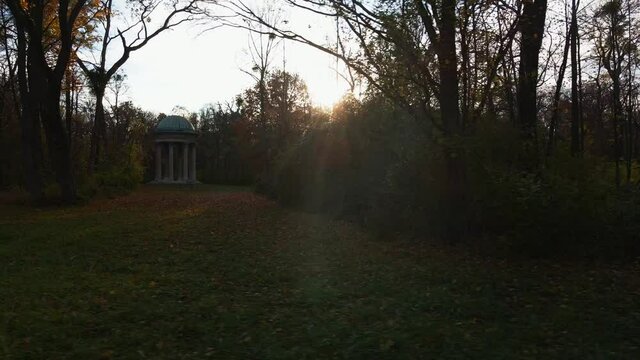 fast sideways flight at a classical style pavilion in a sunlit park on a november evening - autumn colours - near Vienna, Austria