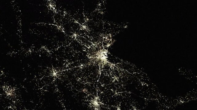 Boston Usa city night lights, urban road pattern fabric map, aerial satellite view from space animation. Based on image furnished by Nasa