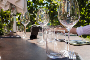Empty glasses set on table for lunch. Close up picture of empty glasses in restaurant. Selective focus..