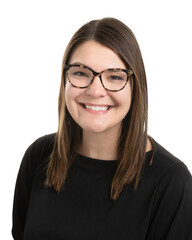 Portrait of a young Caucasian girl with glasses, long brown hair, and wearing a black shirt.