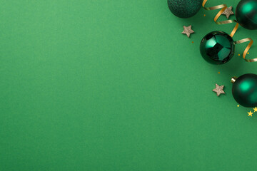 Top view photo of christmas decorations in the upper right corner green balls small stars gold star...