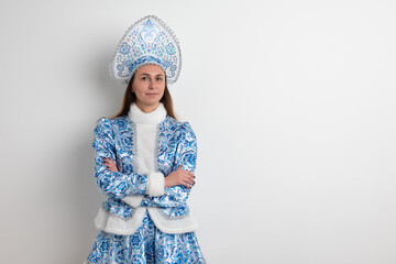 Sexy woman dressed in traditional russian christmas costume of Snegurochka (Snow Maiden),