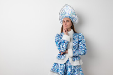 Sexy woman dressed in traditional russian christmas costume of Snegurochka (Snow Maiden),