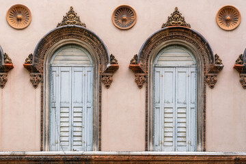 Arched windows in Venice with oriental decoration and closed shutters