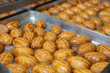 Production of sekerpare dessert in the dessert production factory. Delicious turkish sweet sekerpare on the tray. Turkish Ramadan sweet Sekerpare.