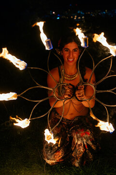 Woman with fire fans at night