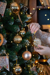 Process of Christmas tree decoration. Person decorates a Christmas tree with a hand
Christmas tree background and Christmas decorations with snow, sparking, glowing. Happy New Year and Xmas theme