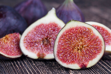 ripe purple figs on a wooden table