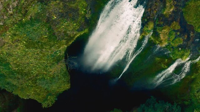 Panoramic flight from the bowels of famous waterfall Gljufrabui in Iceland