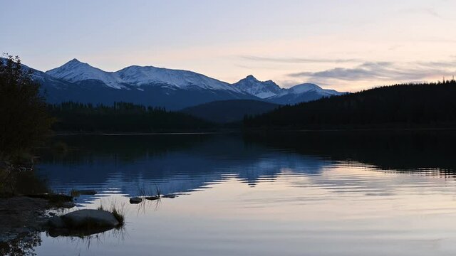 Patricia lake with mountain range and pine forest reflection on the sunset at Jasper national park