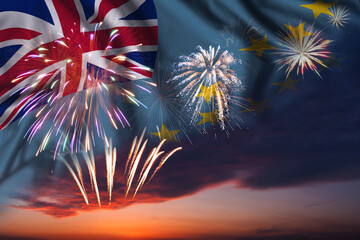 Fireworks in evening sky and flag of Tuvalu