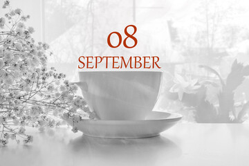 calendar date on light background with porcelain white tea pair and white gypsophila with copy...