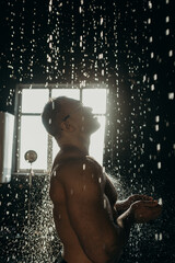 Handsome muscular man in shower.