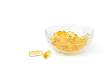 Omega-3 capsules in glass bowl isolated on white background.