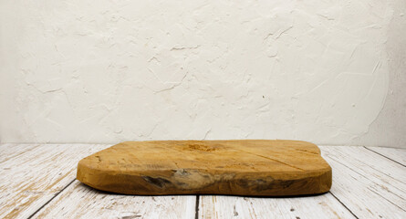 wooden board on a table in front of a white wall with a grunge effect