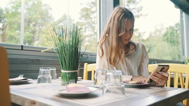 Tween girl waiting for an order in a restaurant.