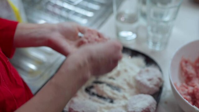 Girl in red longsleeve to cook minced meat cutlets from fresh mea