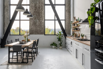 Spacious modern kitchen with large windows and furniture