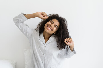Afro american woman stretching up and smiling wide