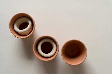 terracotta pots, wooden rings, and paper