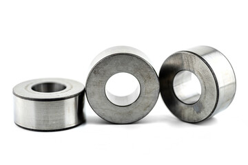Photo of three roller sleeve for needle roller bearings, isolated on a white background.