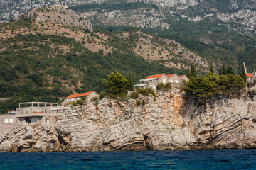 beautiful view from sea of island Sveti-Stefan near Budva in Montenegro, Europe, Adriatic Sea and mountains