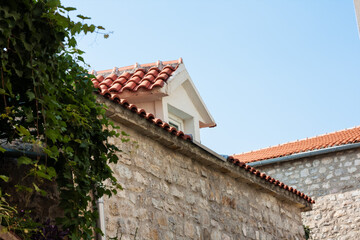 Street and landscape of Old town Budva, Montenegro: medieval city, ancient walls and red tiled roof, beautiful view