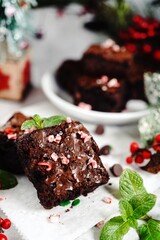Homemade Peppermint fudge brownies on xmas holiday background, selective focus