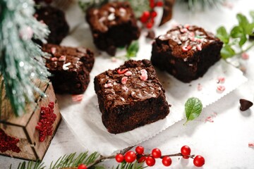 Fototapeta na wymiar Homemade Peppermint fudge brownies on xmas holiday background, selective focus