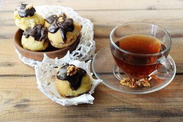 cup of tea and homemade cookies covered with chocolate
