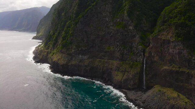 Beautiful waterfall that flows into the sea - Miradouro Veu da Noiva, Madeira. 4k drone shot.