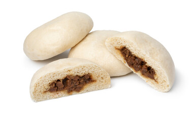 Whole and halved fresh steamed meat filled baozi close up isolated on white background