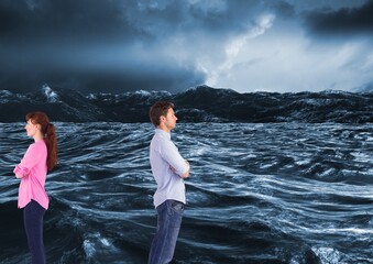 Composite image of sad couple looking away from each other against waves in the sea