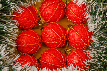 Bright red Christmas balls in green tinsel frame, Christmas decoration, background