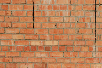 Old brick wall texture of red stone blocks closeup