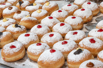 Sufganiot traditional jelly doughnut , bismark covered with powdered sugar eaten during the Hannukah holiday at the Mahane Yehuda market in Jerusalem, Israel
