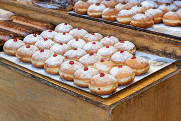 Sufganiot traditional jelly doughnut , bismark covered with powdered sugar eaten during the Hannukah holiday at the Mahane Yehuda market in Jerusalem, Israel
