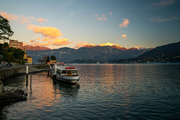 Amazing sunset on lakr Como in winter during Christmas holidays  with snow capped mountains