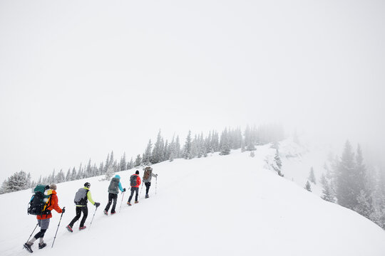 Winter hikers walking into clouds