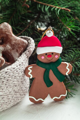 Christmas gingerbread man toy and fir tree branches on white background. Christmas concept.