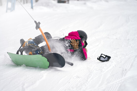 Loss of balance on the t-bar lift when climbing a mountain of snowboarders in a pair. Copy space.